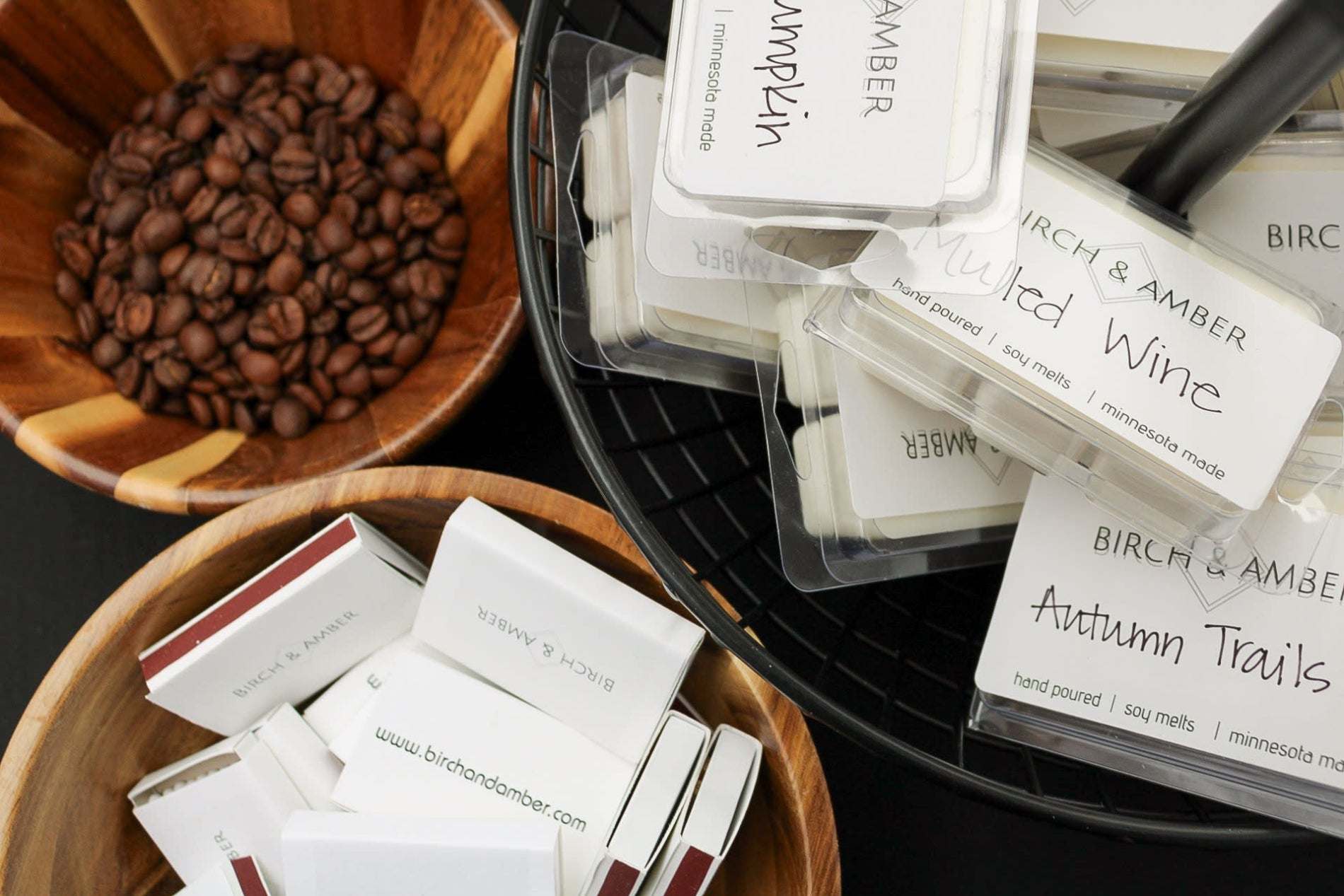 Birch & Amber product samples with coffee beans and a black basket in the background