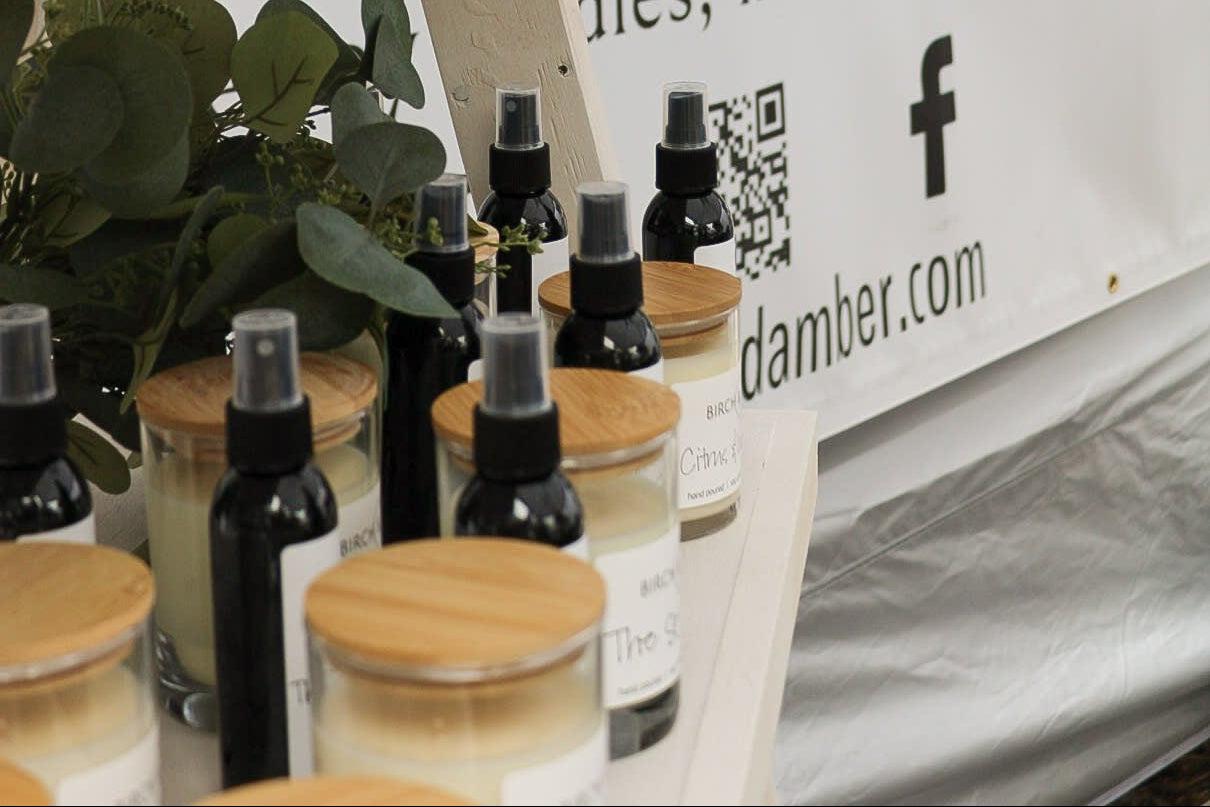 Bottles and containers on a table with a 'Amber' sign in the background